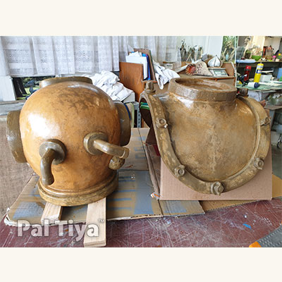 Diving helmet and breast plate side by side