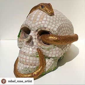 Mosaic skull with snake through eye